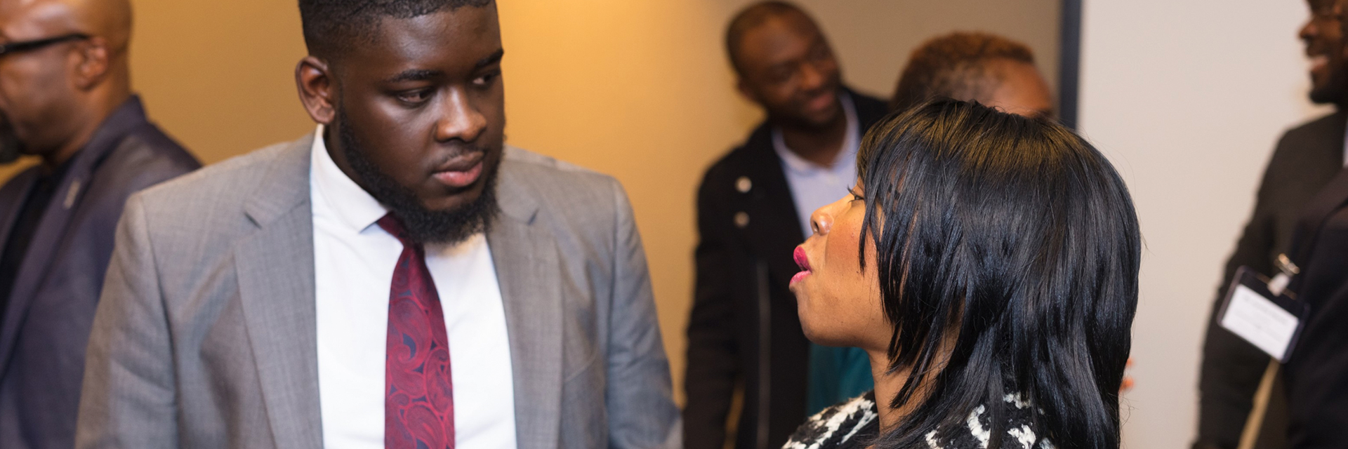 Two attendees speaking face to face at a Cee4Bee event