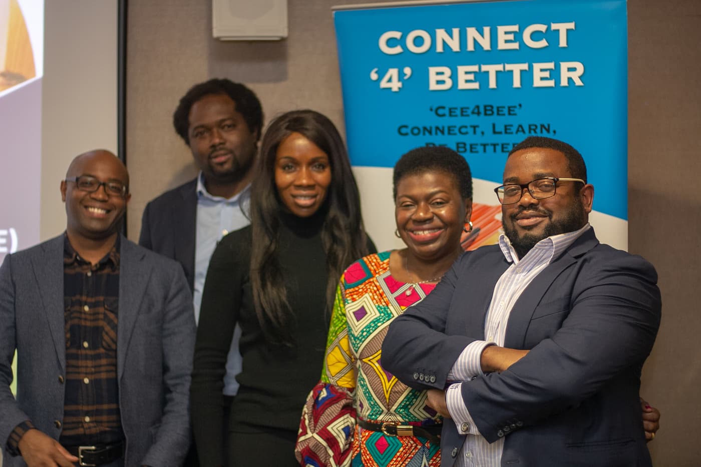 Organisers and speakers together in front of a Connect4Better banner