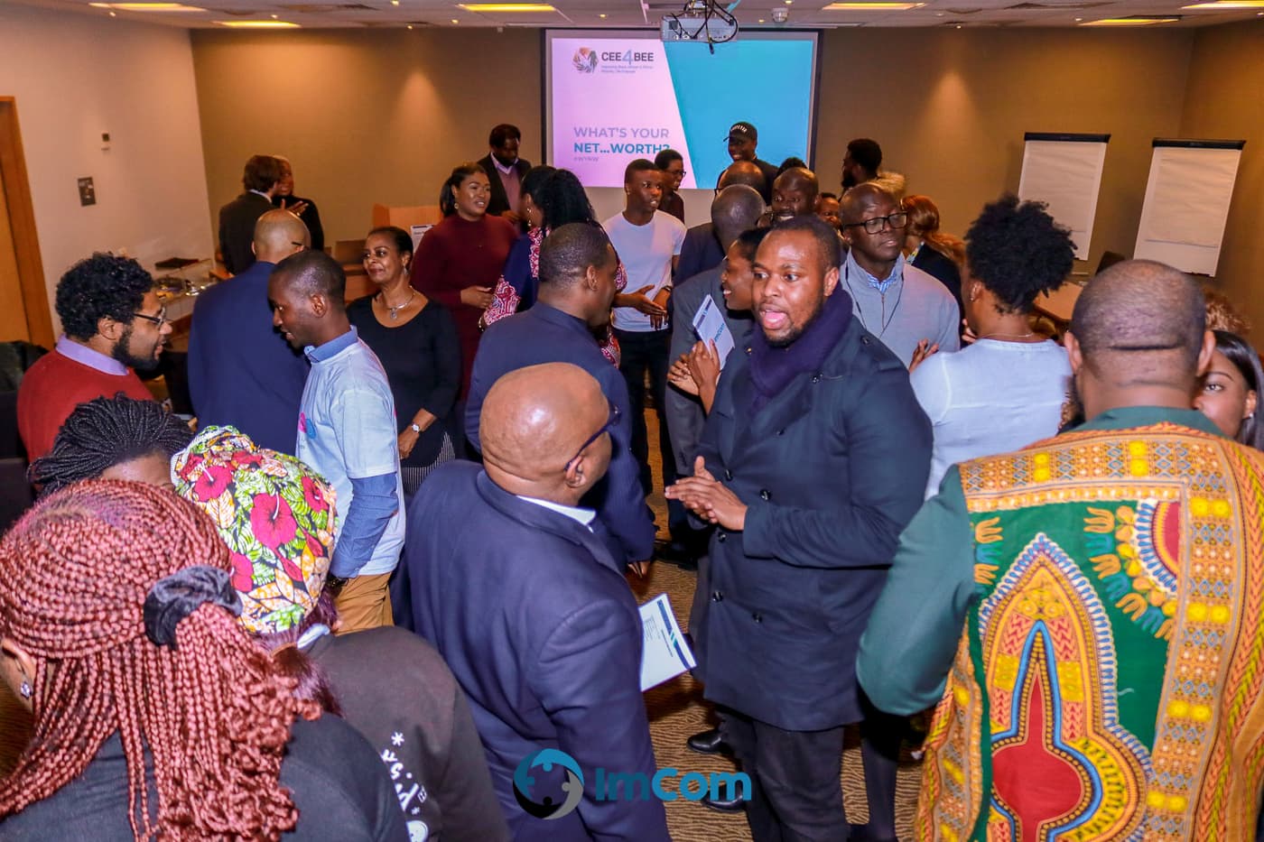 A full room of attendees networking