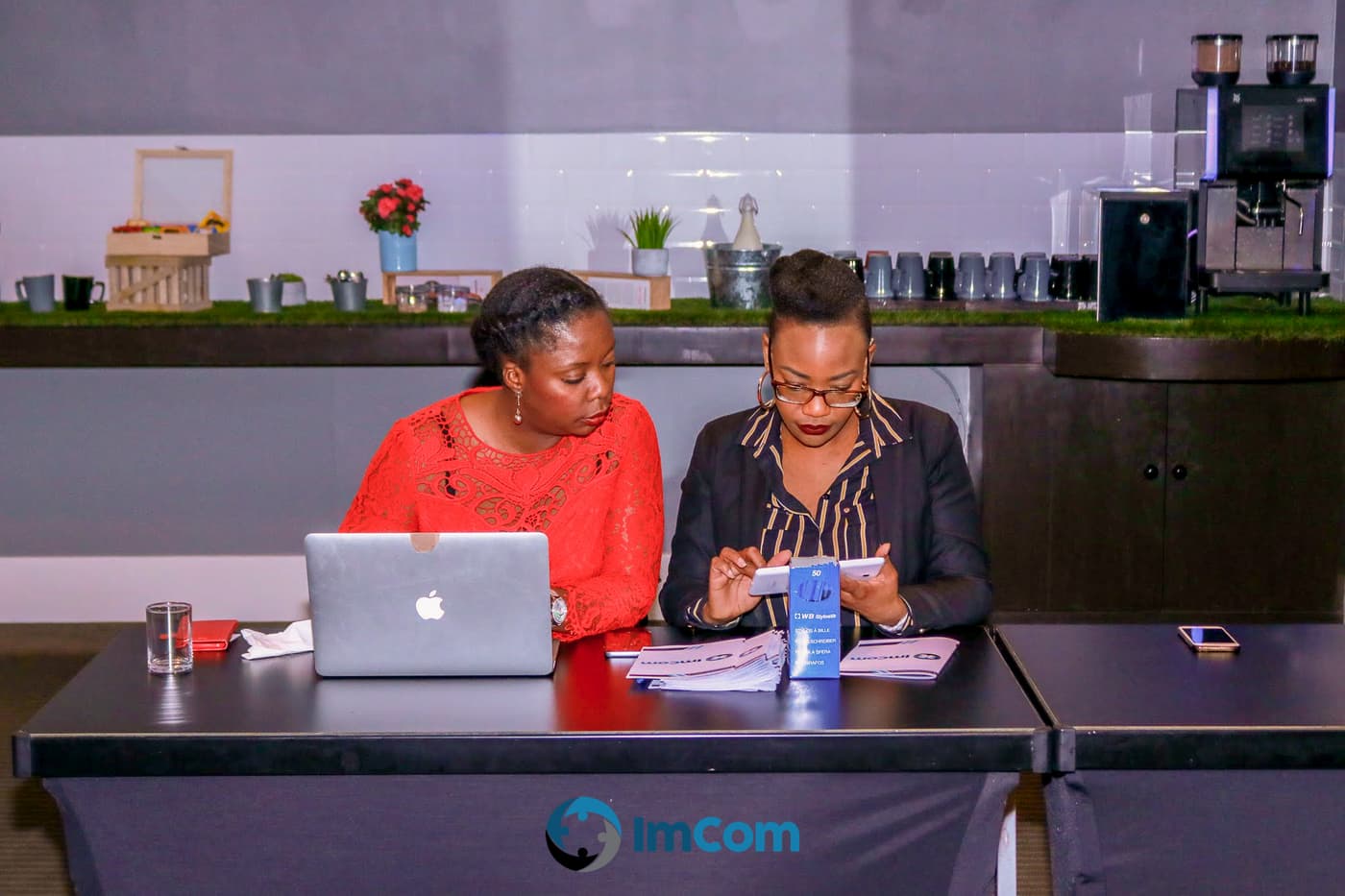 Two organisers setting up the welcome desk