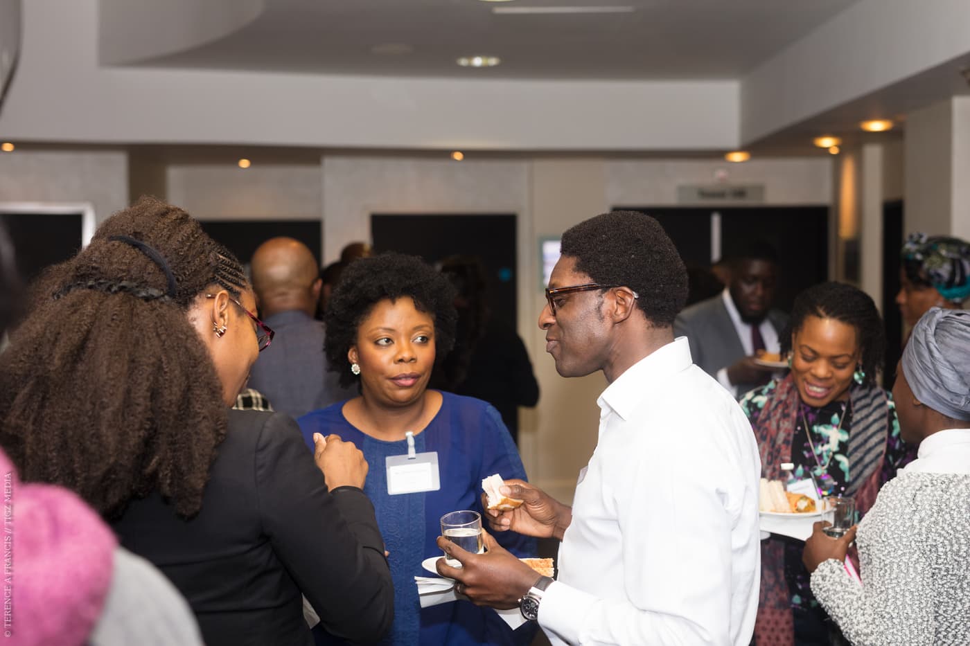 Two attendees talking over refreshments