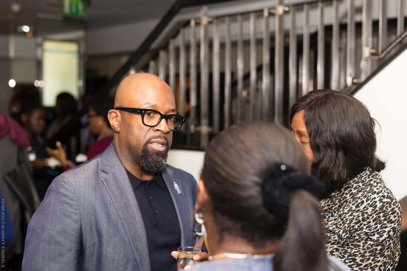 An attendee in conversation during the reception