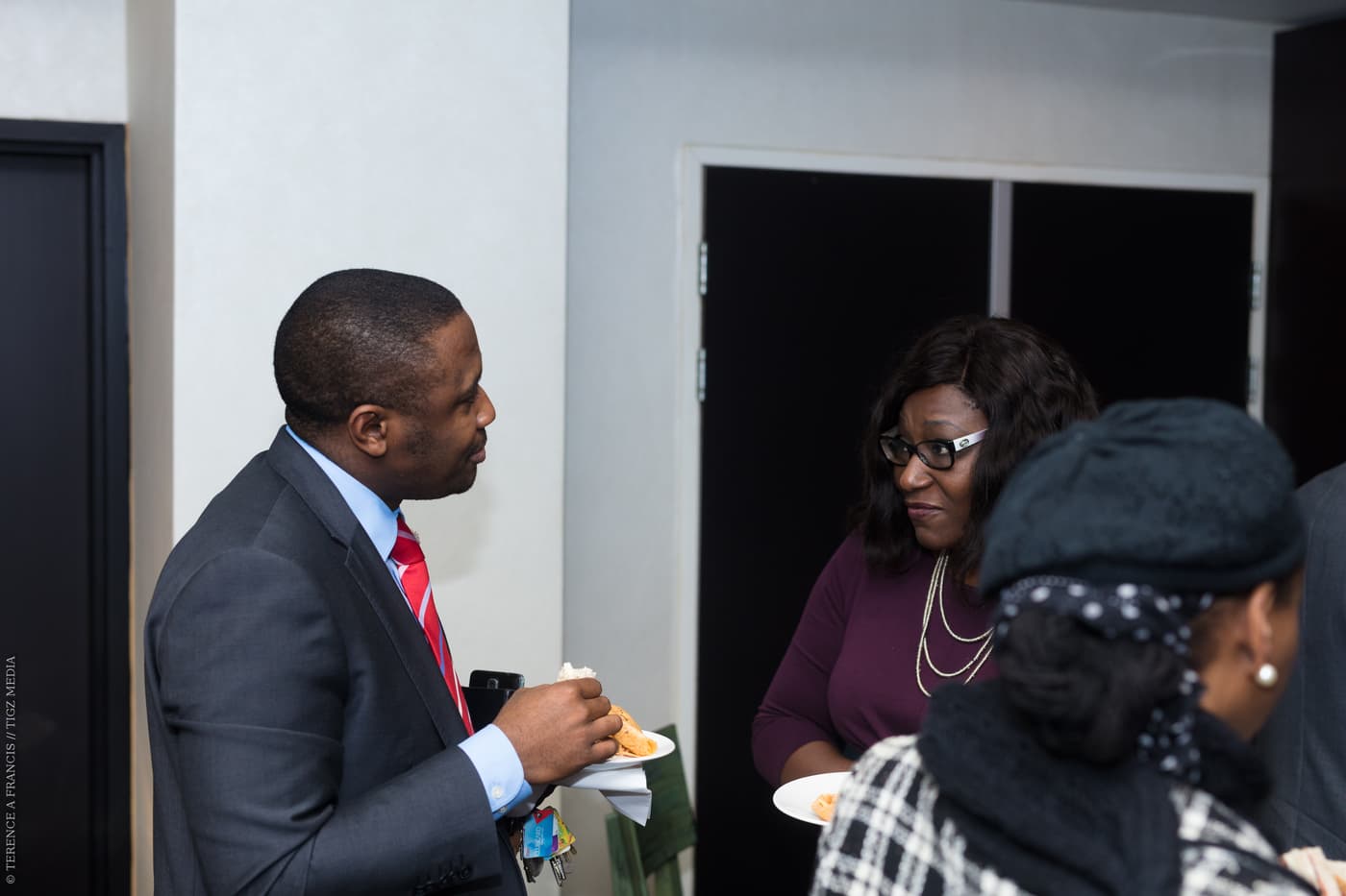Two attendees talking near the entrance
