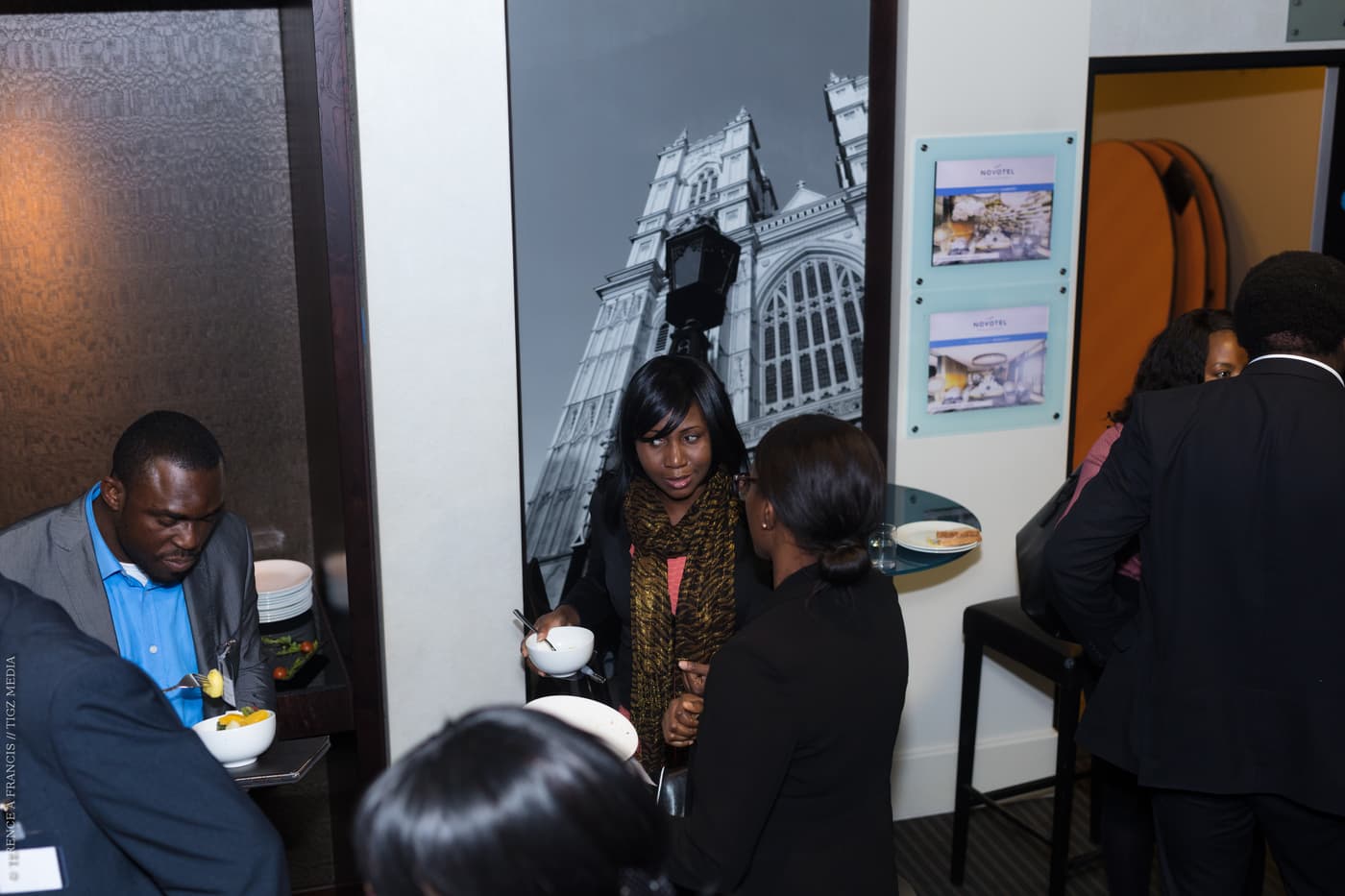 Two attendees talking beside the display boards
