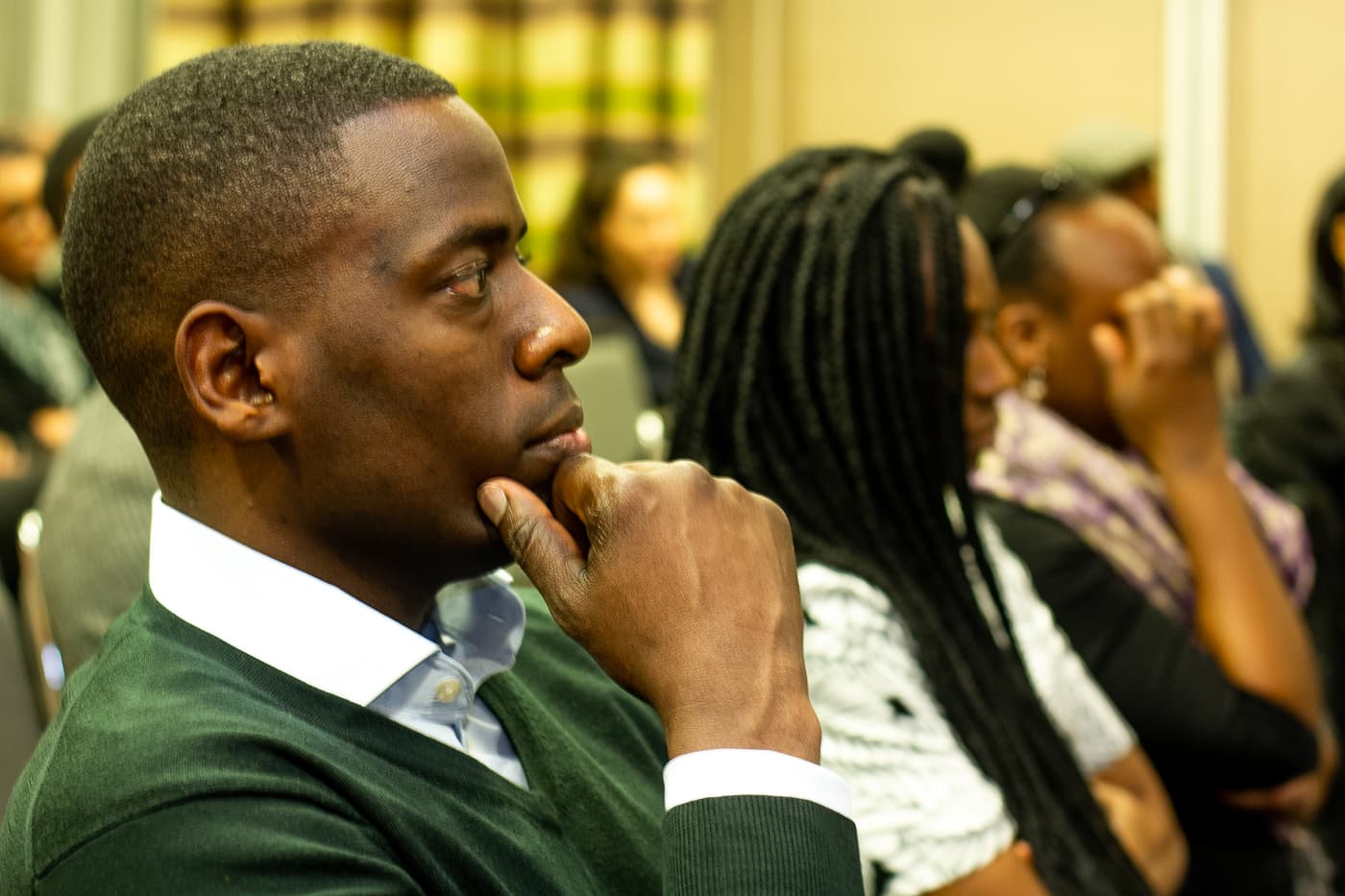 An attendee listening closely during a pitch