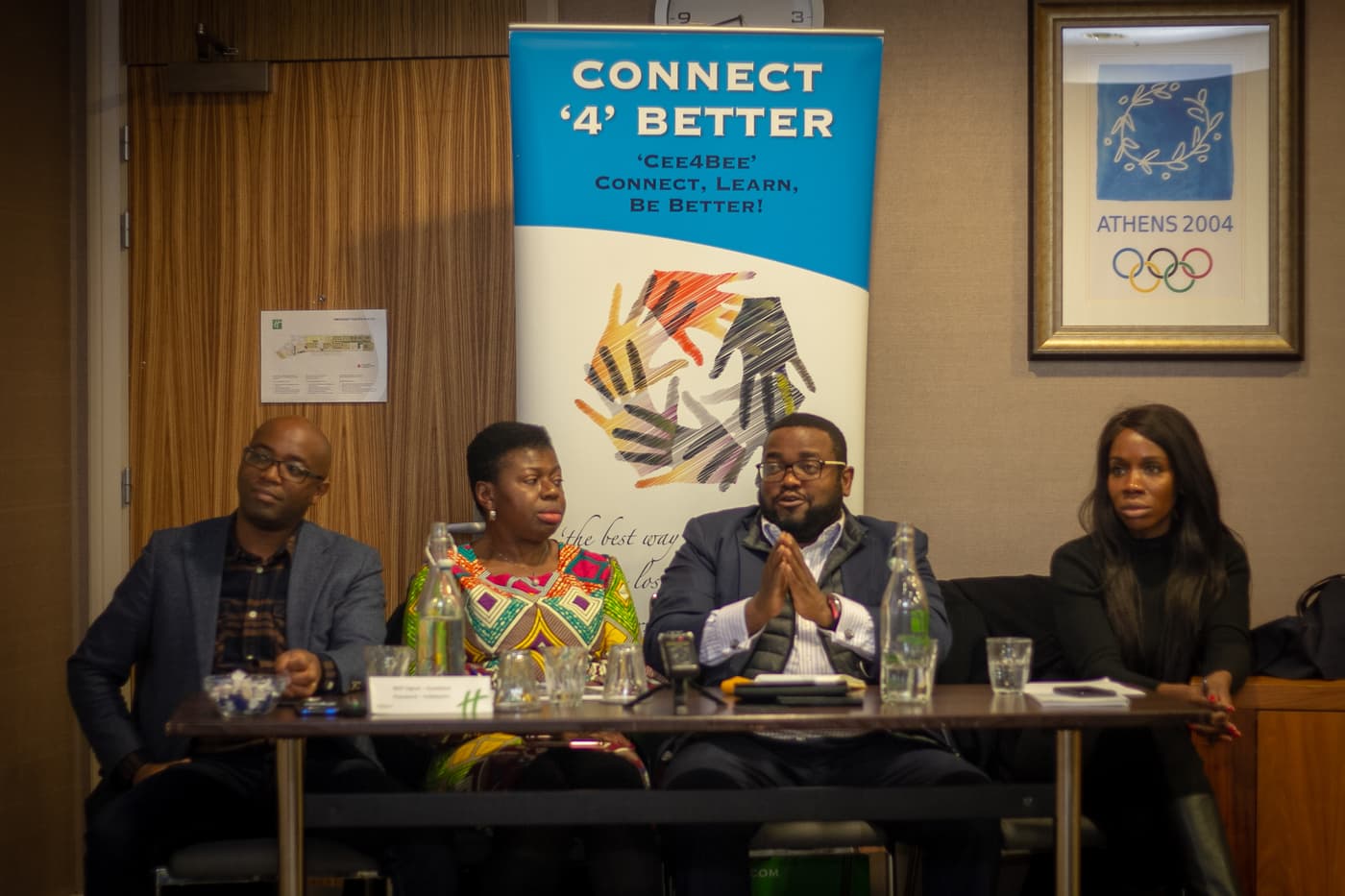 The panel seated beside the Connect4Better banner