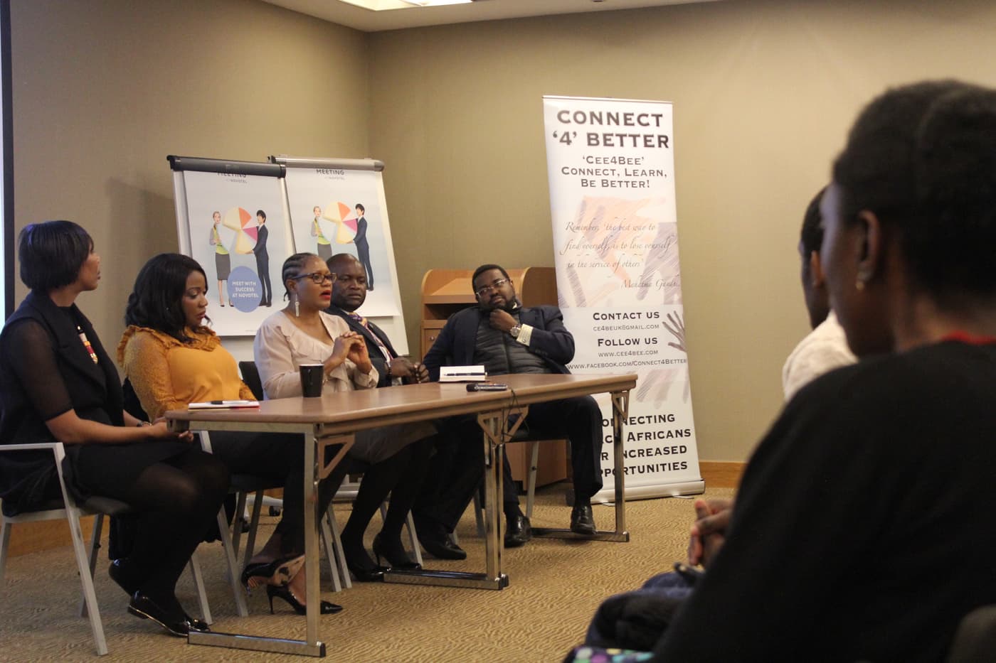 Panellists at the top table beside a Connect4Better banner