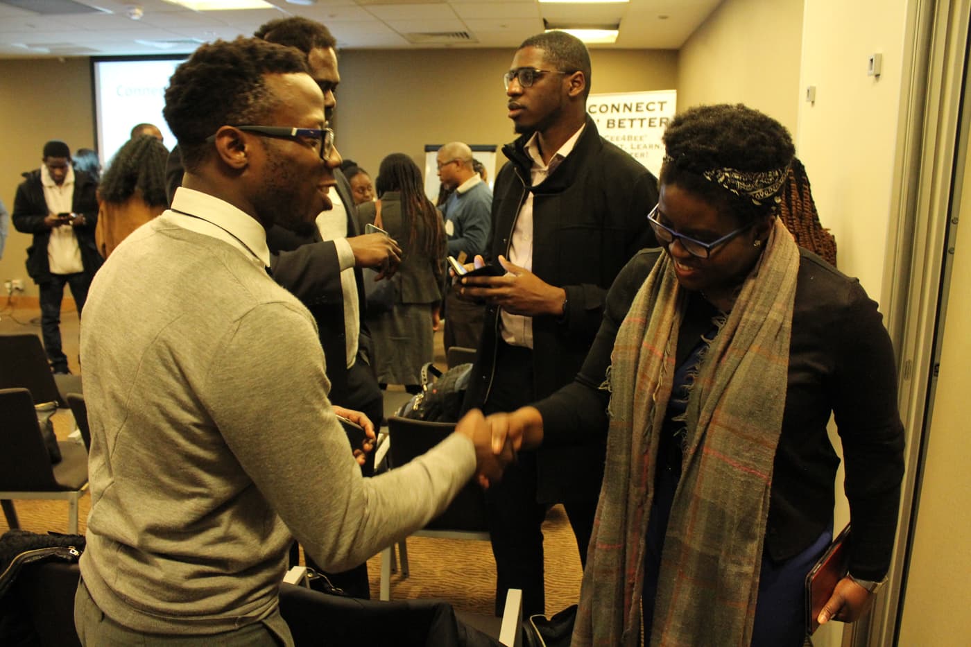 A handshake between two attendees during the networking hour