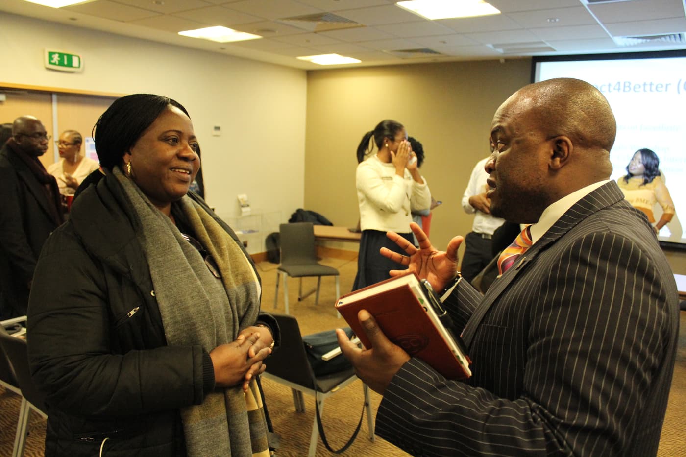 Two attendees comparing notes