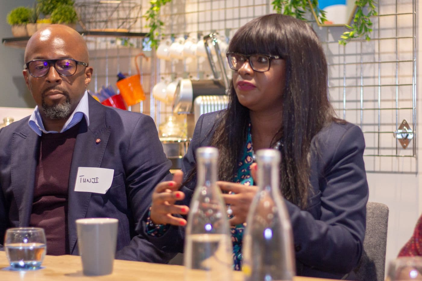 Two speakers in conversation at the panel table