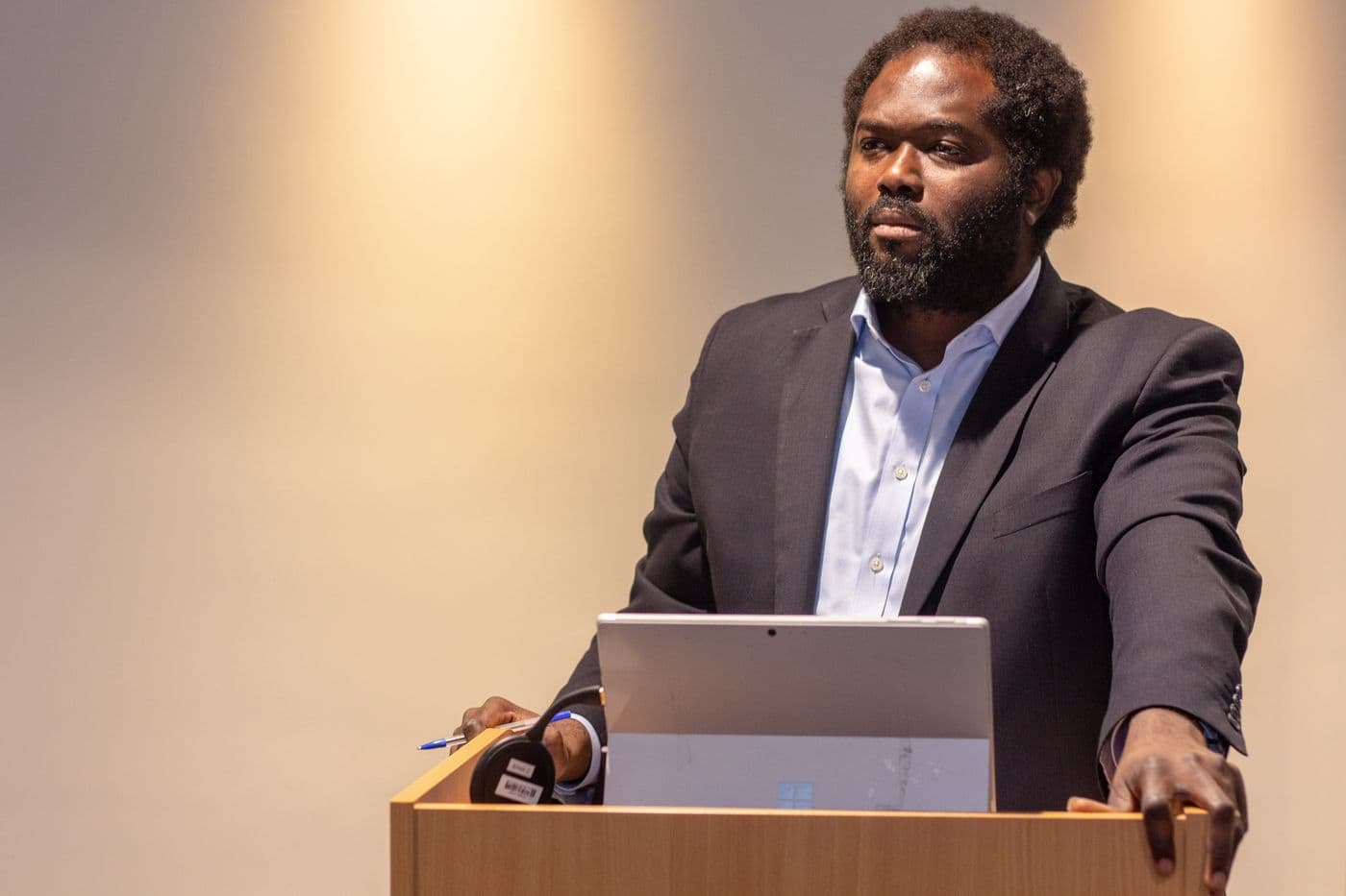 A speaker presenting from the lectern