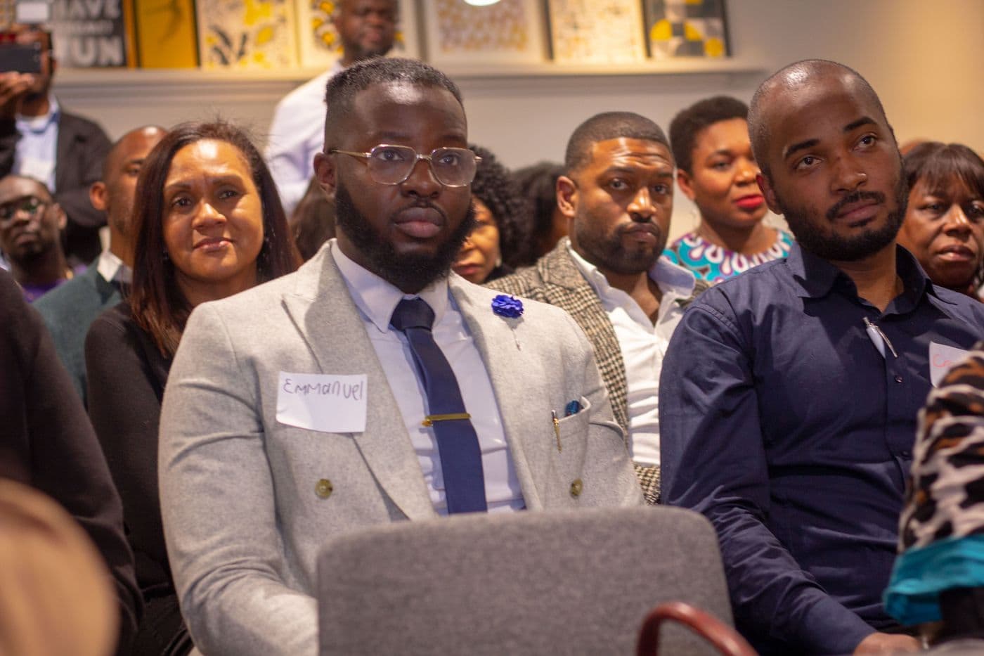 Attendees seated together, listening