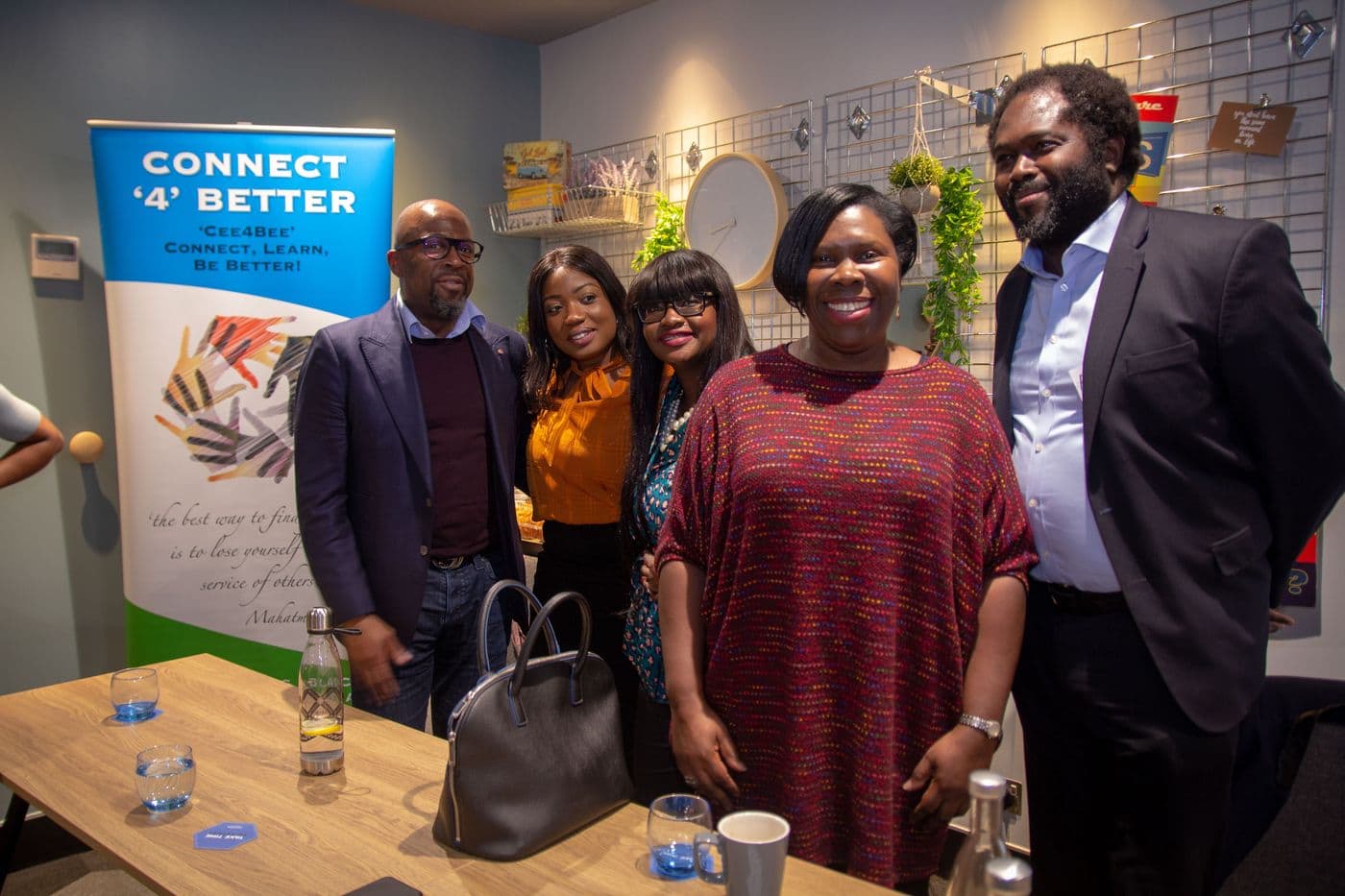 A group of attendees beside the Connect ’4’ Better banner