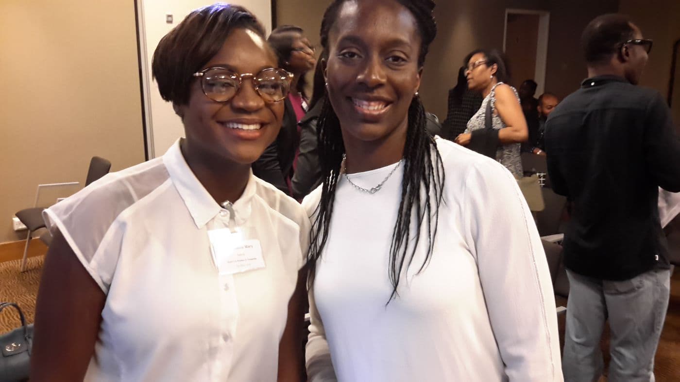 Two attendees smiling for the camera