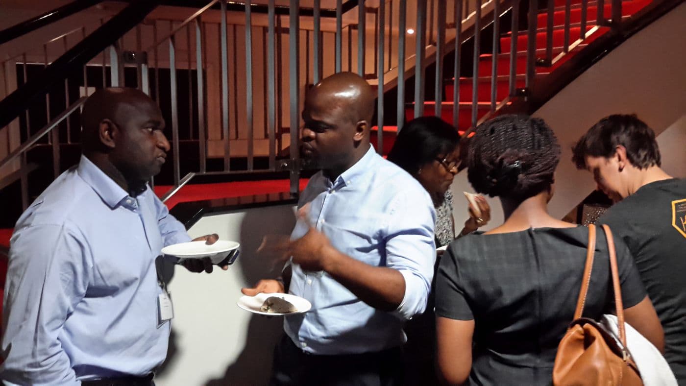Attendees talking over plates of food