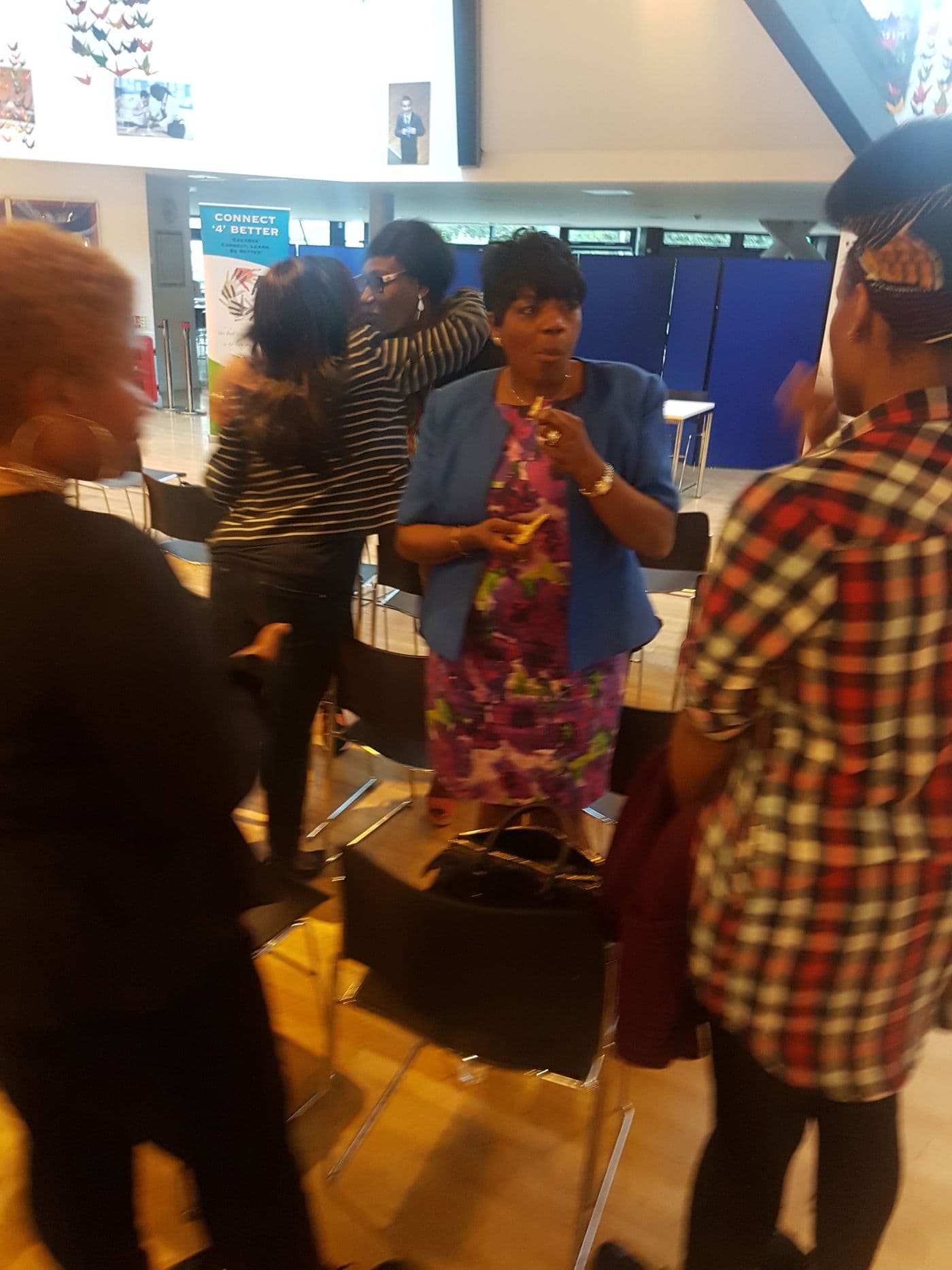 Attendees talking around the refreshments table