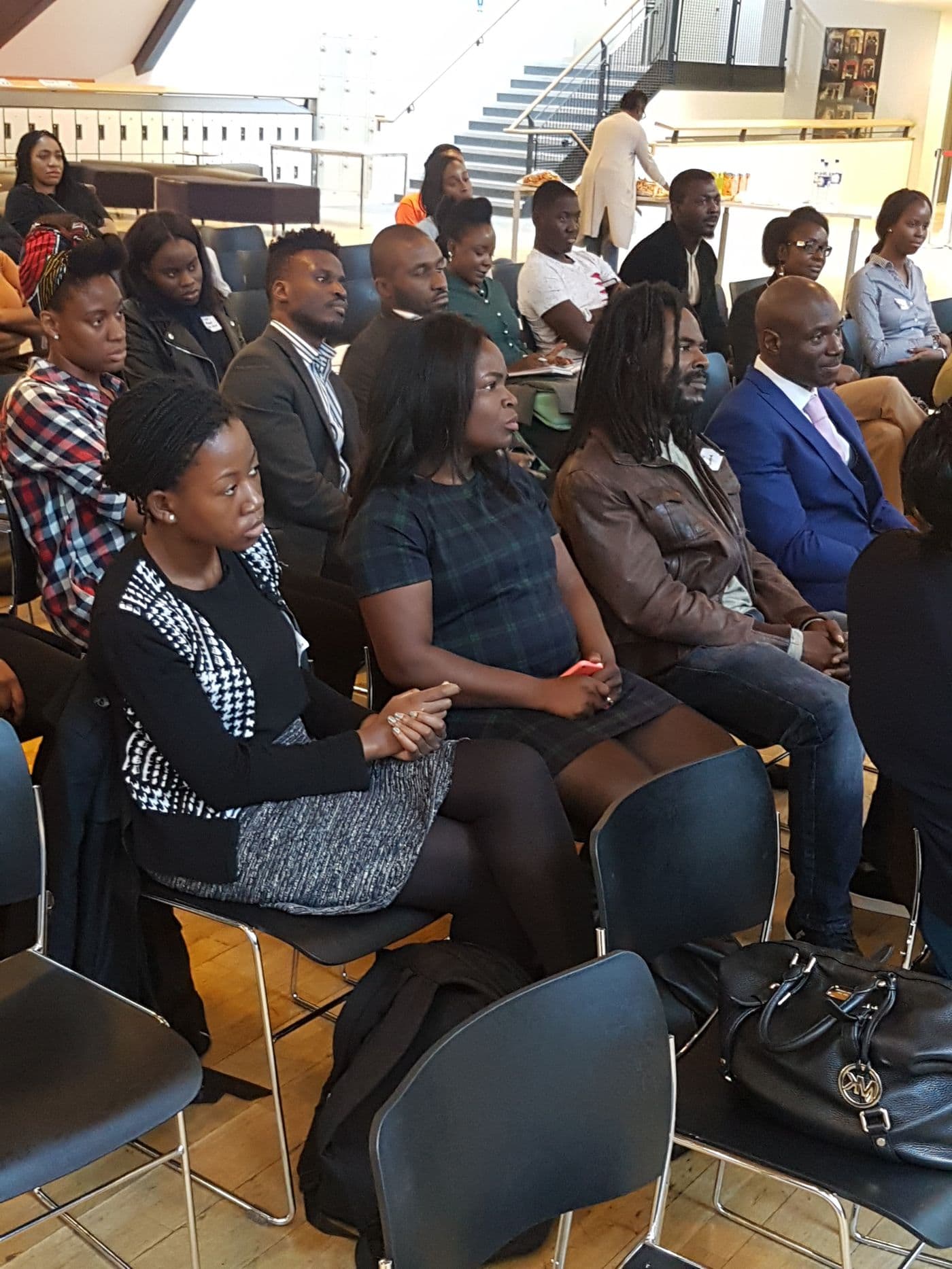 Young people seated and listening