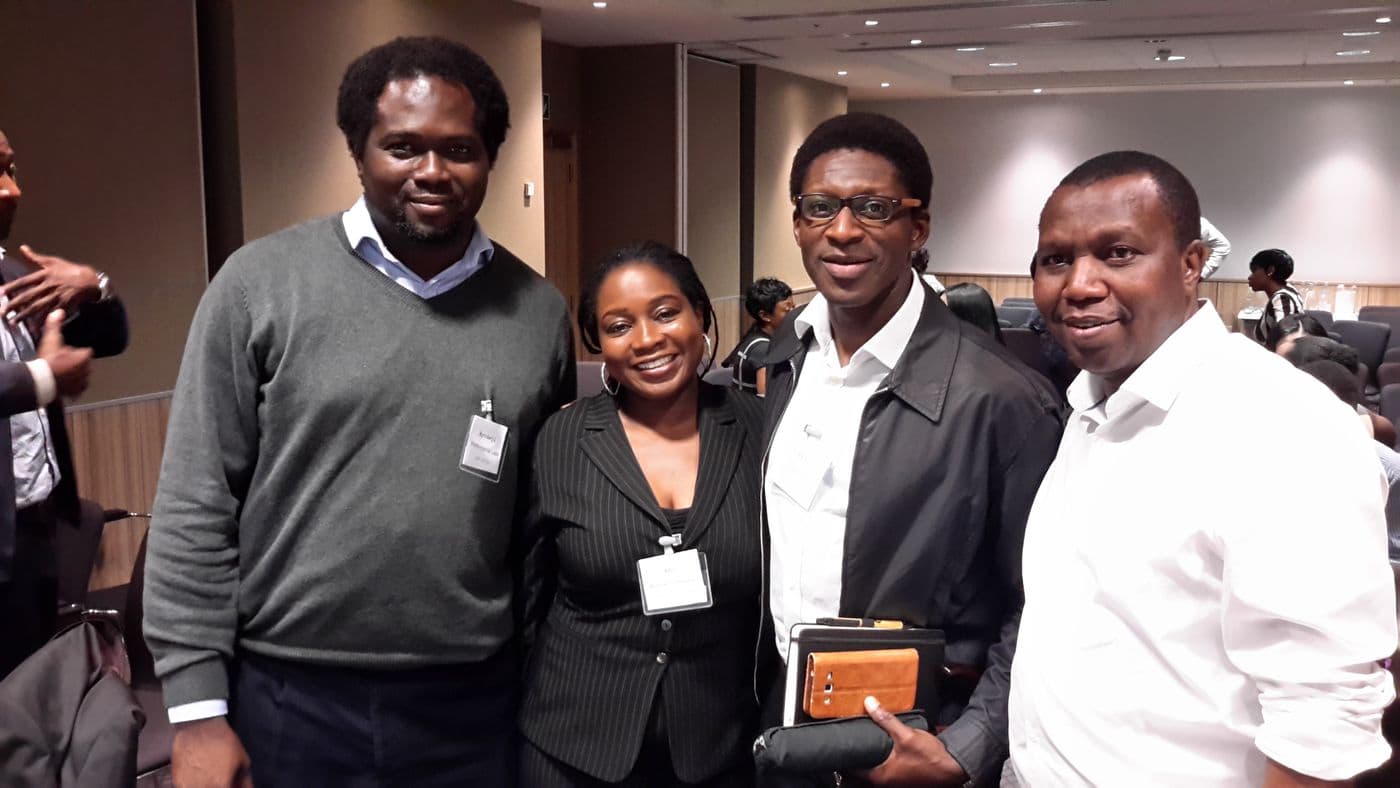 Four attendees together for a photograph