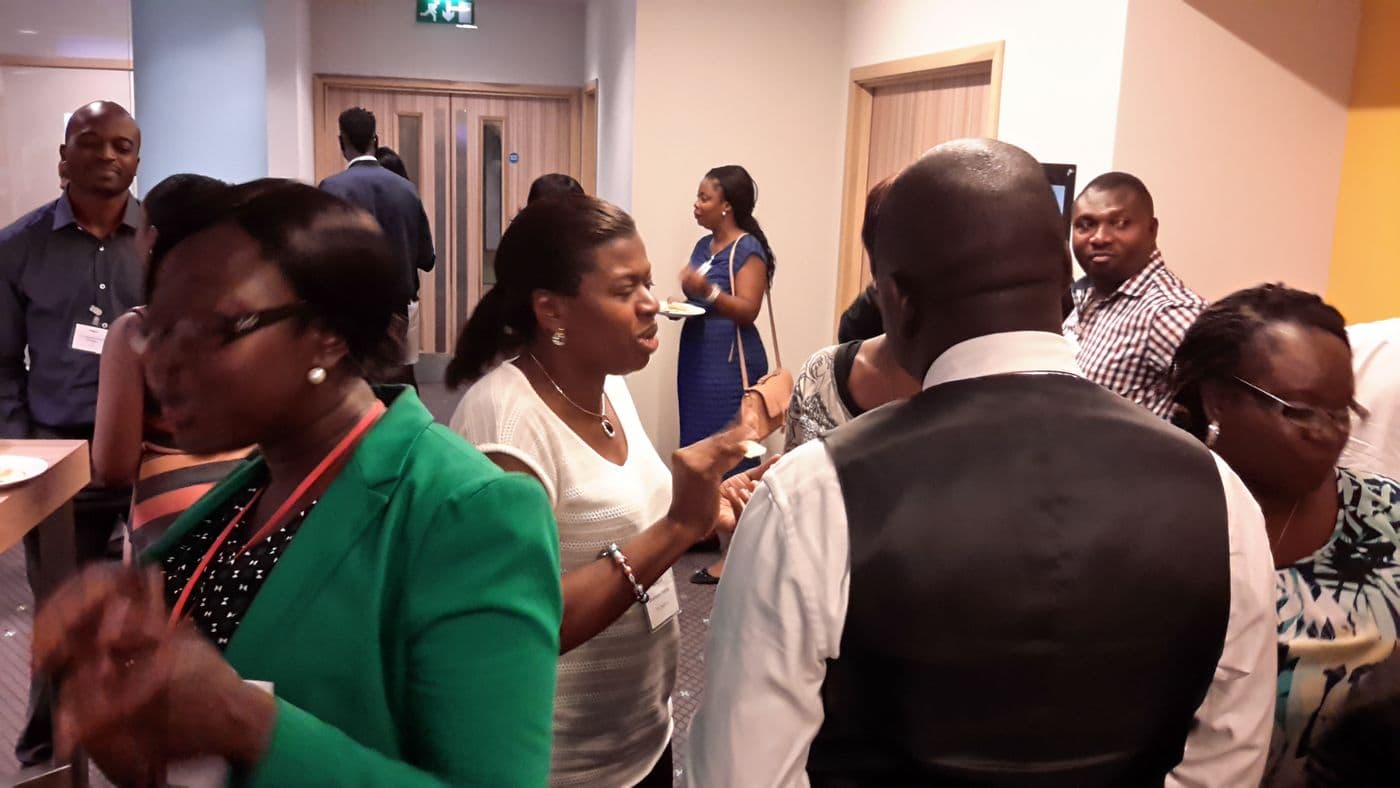 A group of attendees in animated conversation
