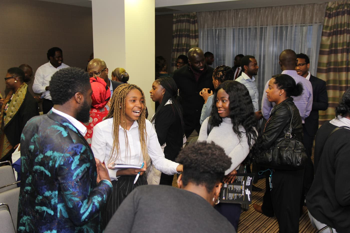 A busy room of attendees networking