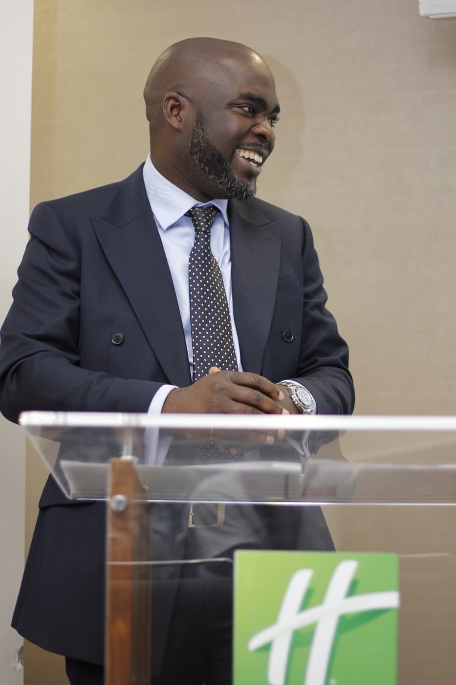 A speaker addressing the room from the lectern