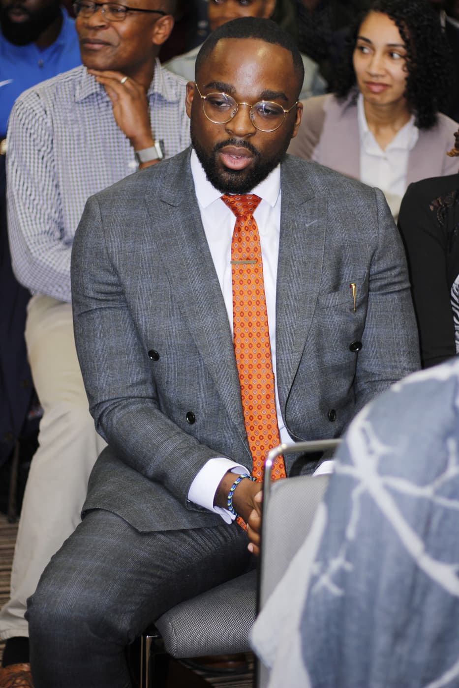 An attendee listening from the audience