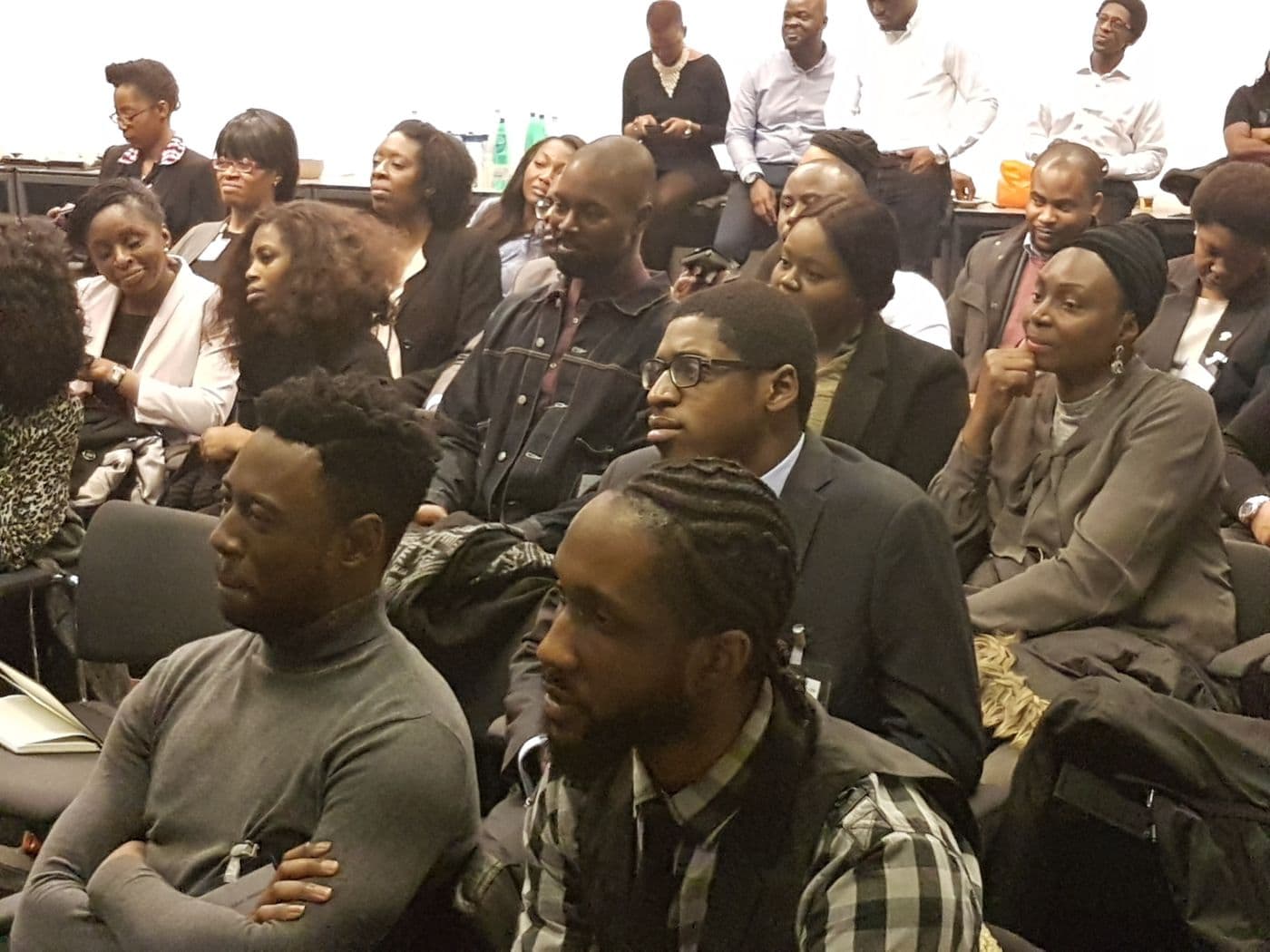 Attendees listening from the middle of the room