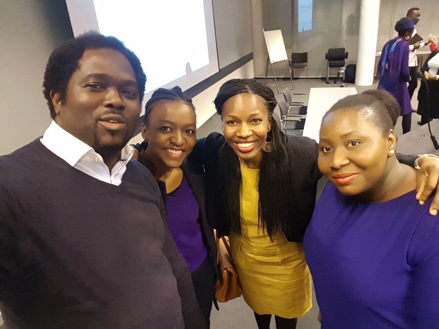 Four attendees together after the talks