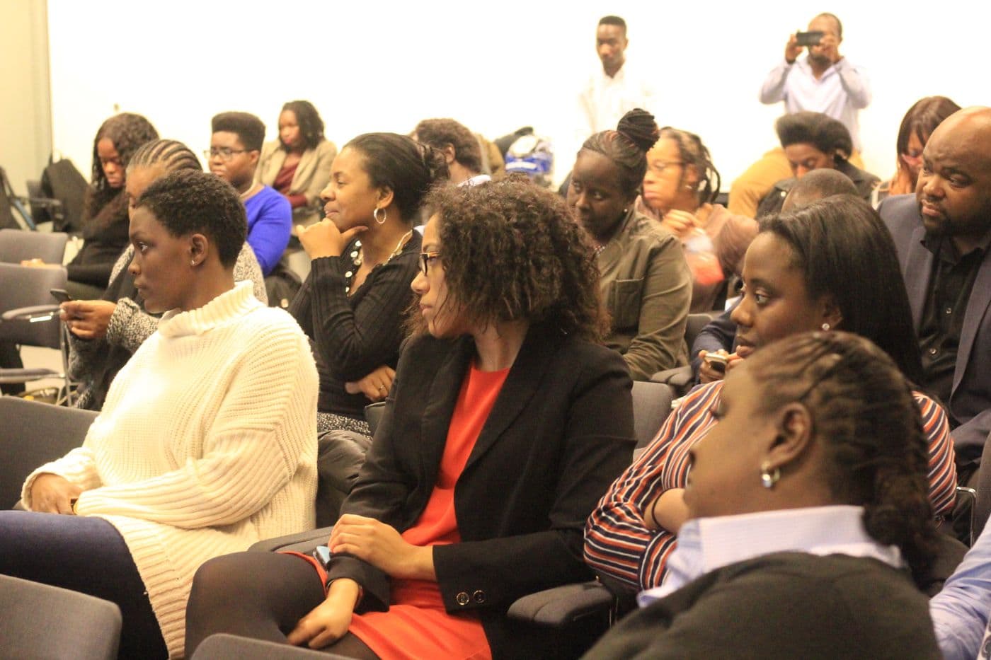 The audience seated and listening