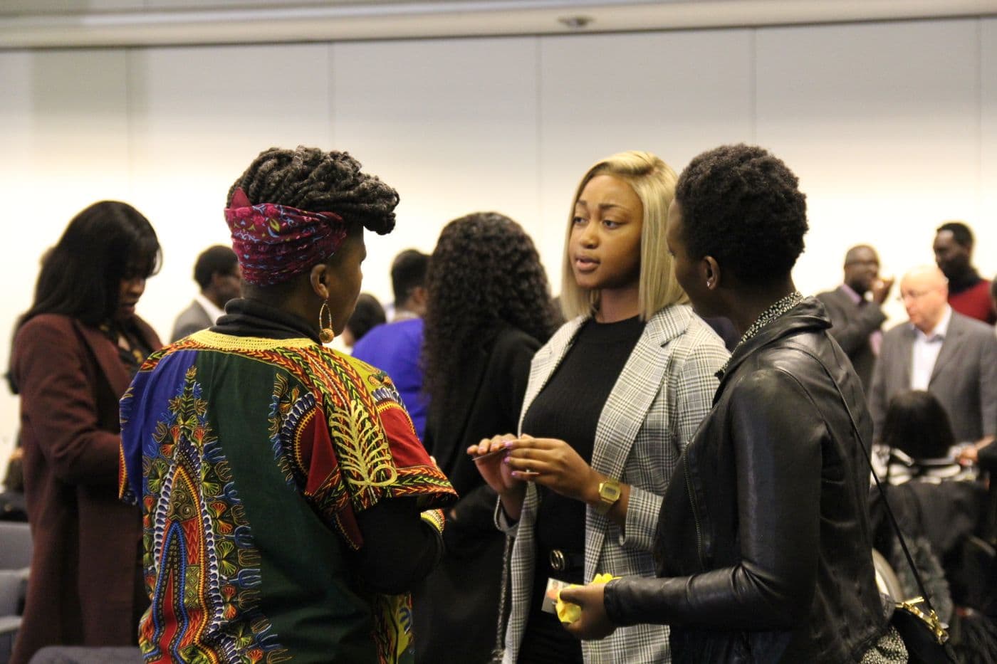 A group of attendees talking during the break