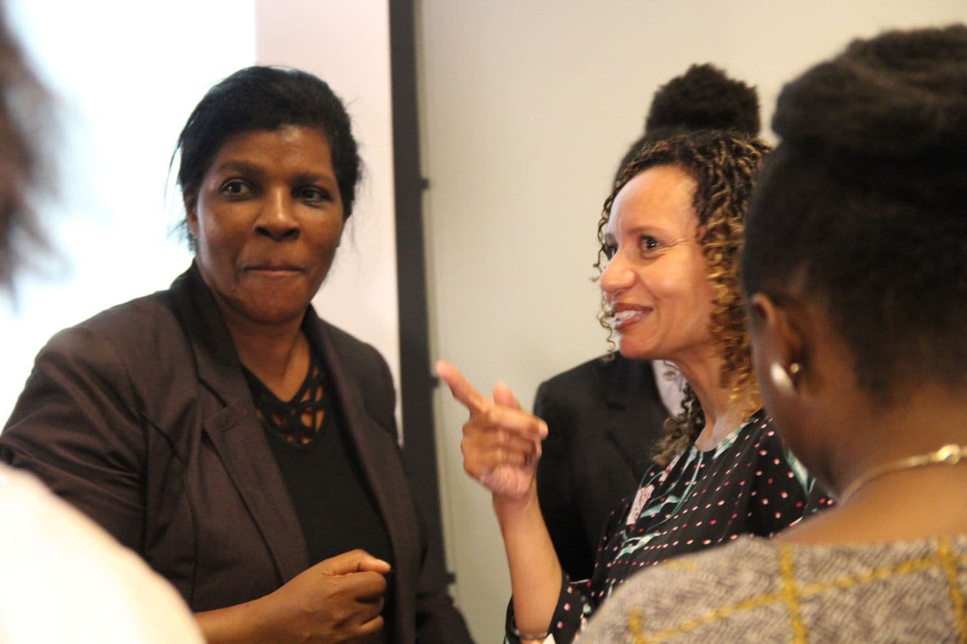 Two attendees talking closely during the reception