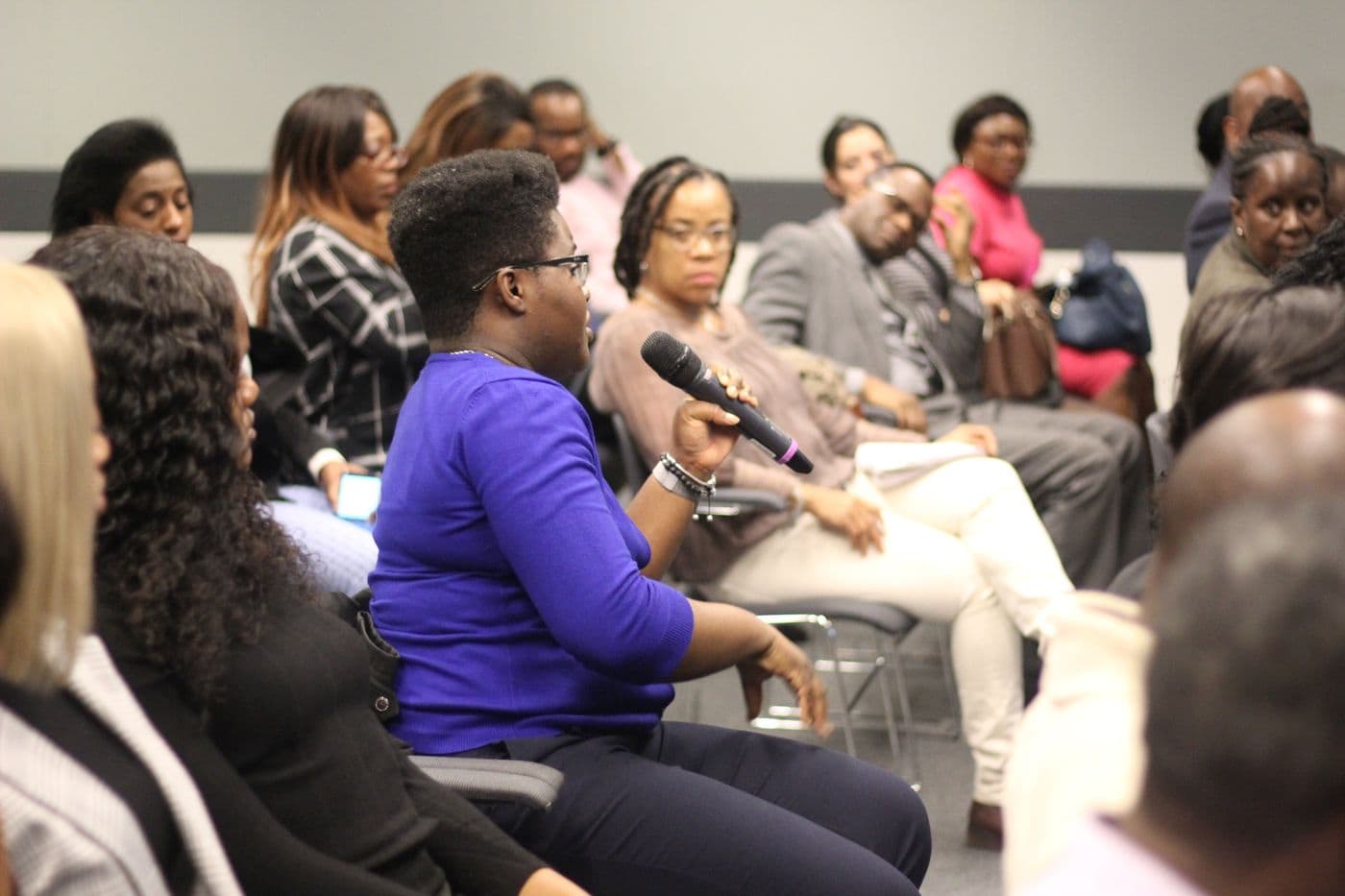 An attendee speaking into a microphone from the floor