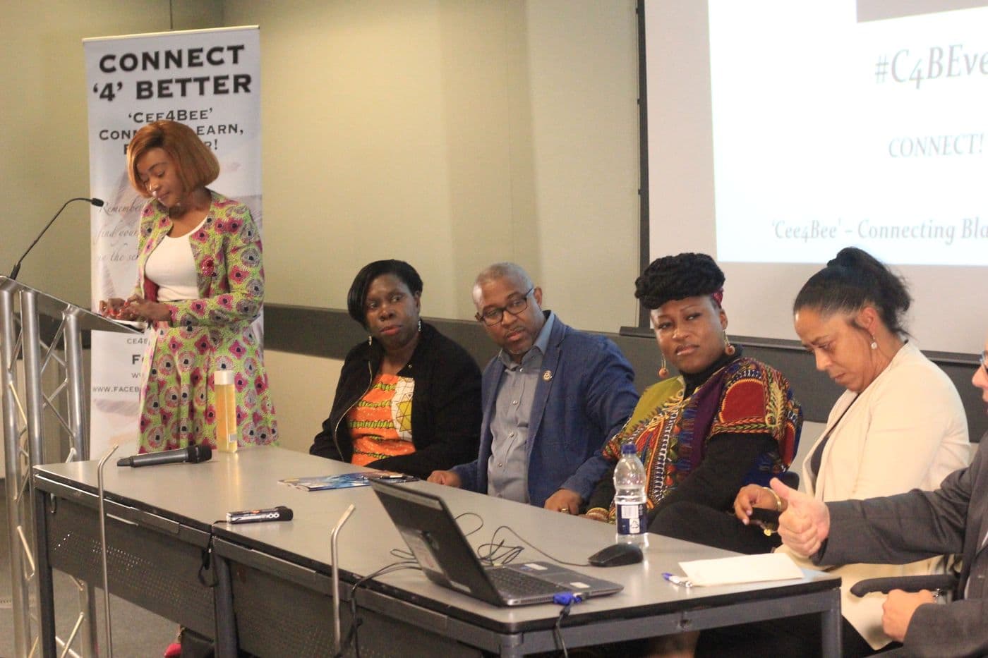 The panel seated behind the table as a speaker presents