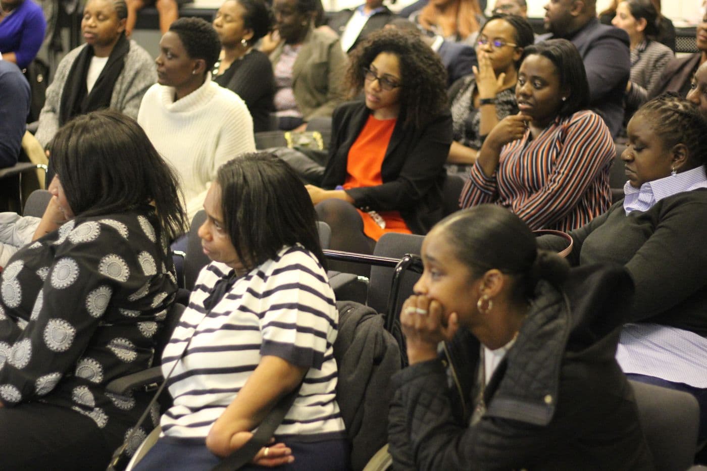 The audience listening from the back of the room