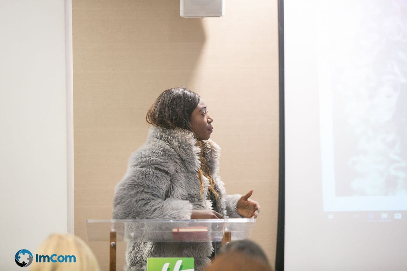 A speaker presenting from the lectern