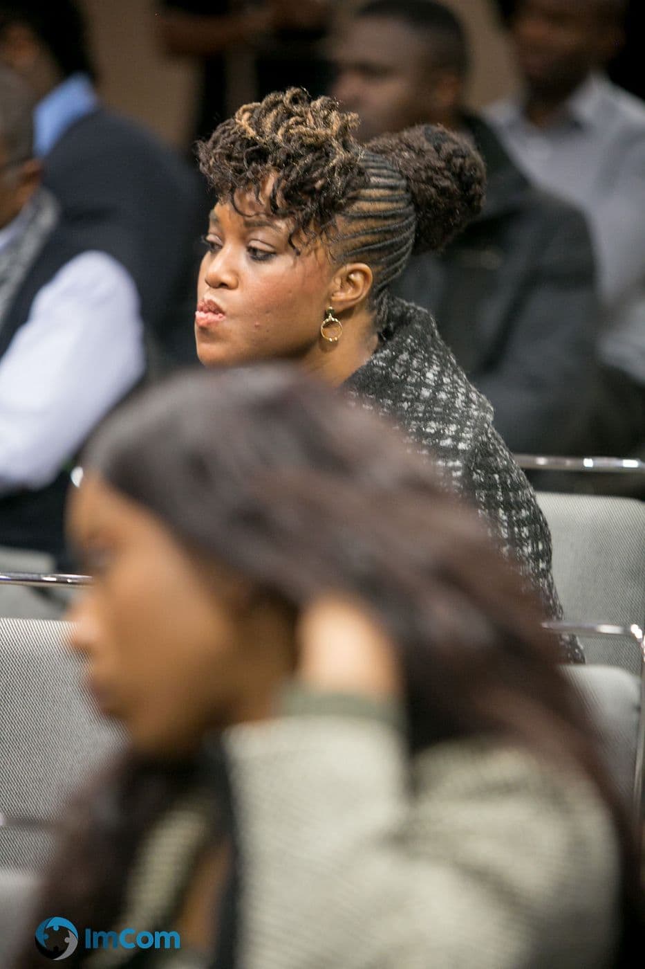 An attendee listening from the audience