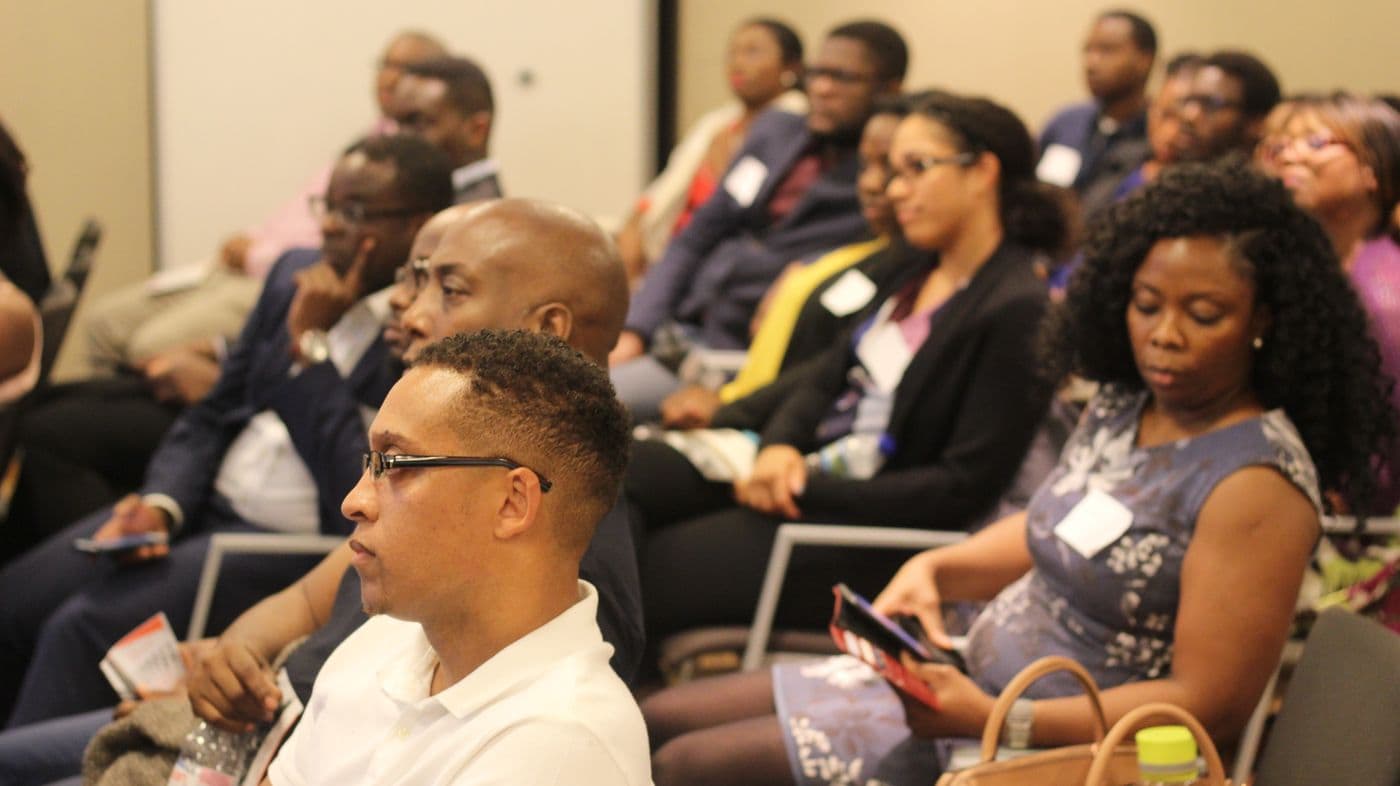 Attendees listening from the middle of the room