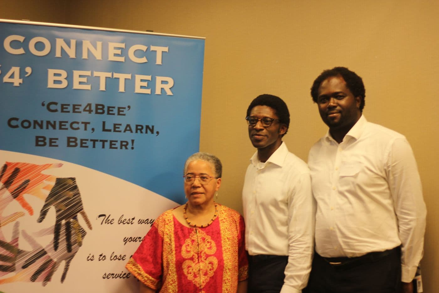 Two attendees beside the Connect ’4’ Better banner
