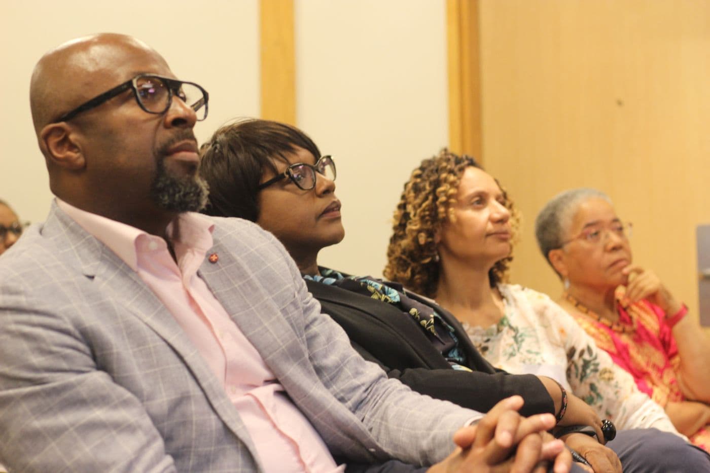 Attendees listening from the middle rows